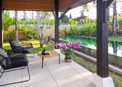 Cozy covered patio with seating area and view of a swimming pool