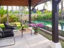 Cozy covered patio with seating area and view of a swimming pool