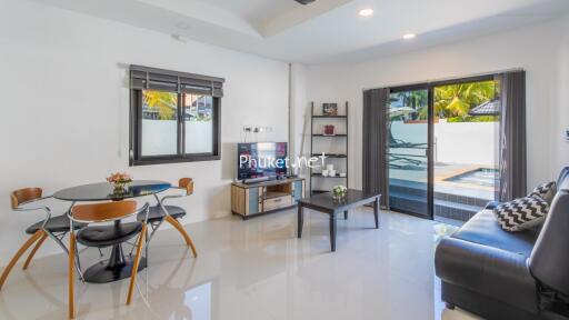 modern living room with dining area and pool view