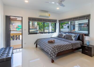 Modern bedroom with large windows and balcony