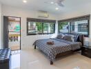 Modern bedroom with large windows and balcony