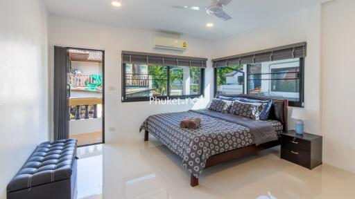 Modern bedroom with large windows and balcony