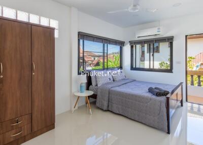 Modern bedroom with large bed and wooden wardrobe