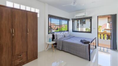 Modern bedroom with large bed and wooden wardrobe