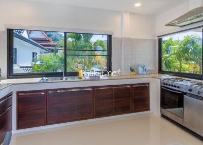 Modern kitchen with large windows and stainless steel appliances