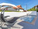 Swimming pool with lounge chairs and umbrella