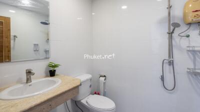 Modern bathroom with sink, toilet, and shower