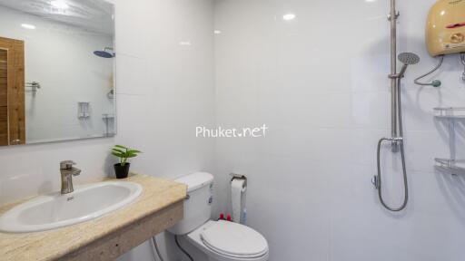 Modern bathroom with sink, toilet, and shower