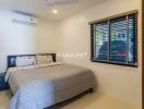 Bedroom with bed, air conditioning, fan, and window with view