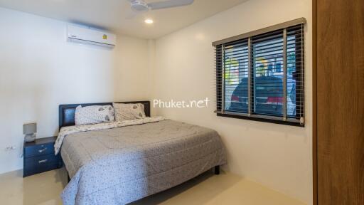 Bedroom with bed, air conditioning, fan, and window with view