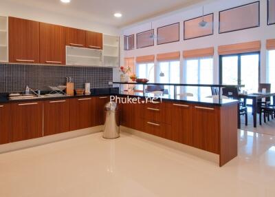 Modern kitchen with wooden cabinets and dining area