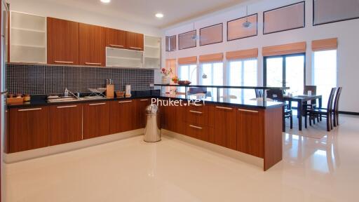 Modern kitchen with wooden cabinets and dining area