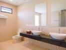 Modern bathroom with dual sinks and large mirror