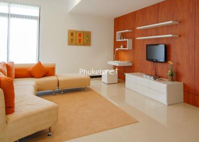 Modern living room with orange accents and wooden wall paneling