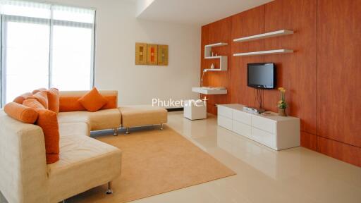 Modern living room with orange accents and wooden wall paneling