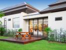 Outdoor seating area with wooden deck and greenery