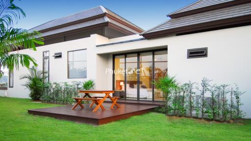 Outdoor seating area with wooden deck and greenery