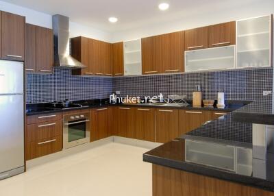 Modern kitchen with wooden cabinets and black countertops