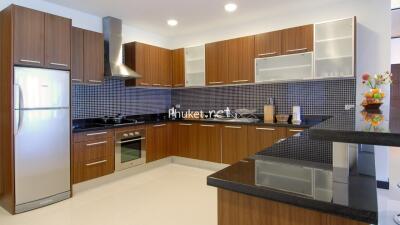 Modern kitchen with wooden cabinets and black countertops