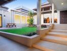 Modern home courtyard with greenery and seating area