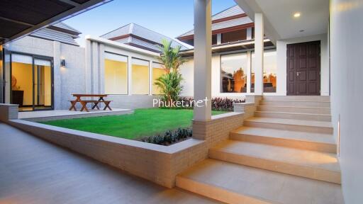 Modern home courtyard with greenery and seating area