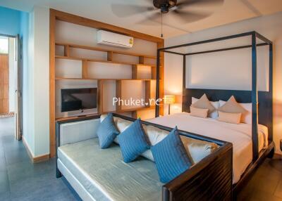 Spacious bedroom with king-size bed, seating area, and modern amenities