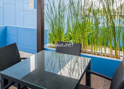 Outdoor seating area with glass table and chairs