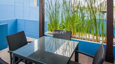 Outdoor seating area with glass table and chairs