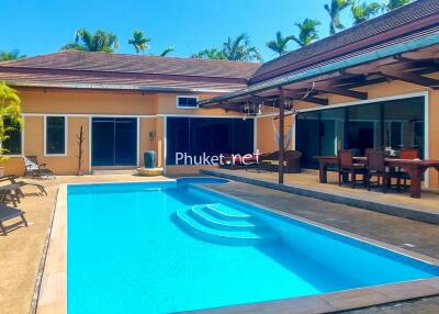 Outdoor pool area with adjacent patio and building