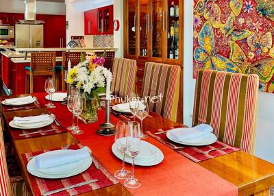 Colorful dining room setup with a view into the kitchen