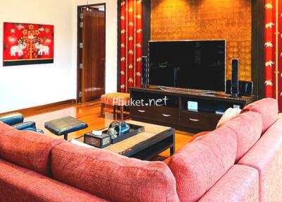 Living room with red sofa and entertainment center