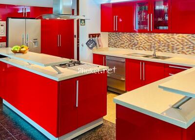 Modern kitchen with red cabinets and white countertops