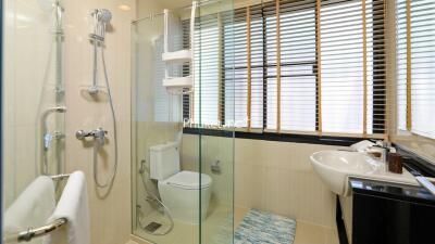 Modern bathroom with glass shower enclosure and large window