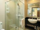 Modern bathroom with glass shower and white sink