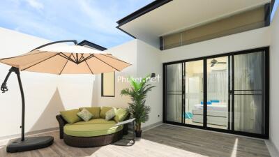 Modern outdoor patio with furniture and umbrella