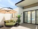 Modern outdoor patio with furniture and umbrella