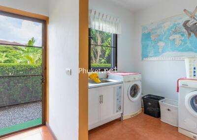 Laundry room with washing machine, dryer, and outdoor view