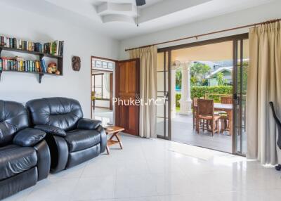 Living room with leather seating and view to patio