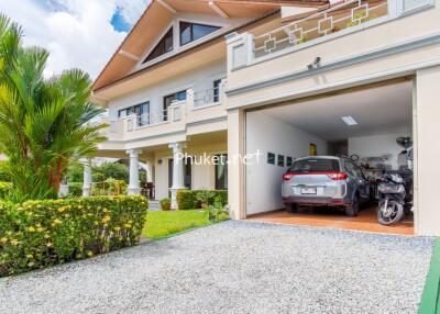 Two-story house with garage and garden