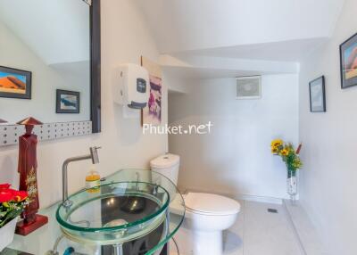 Modern bathroom with glass sink and white fixtures