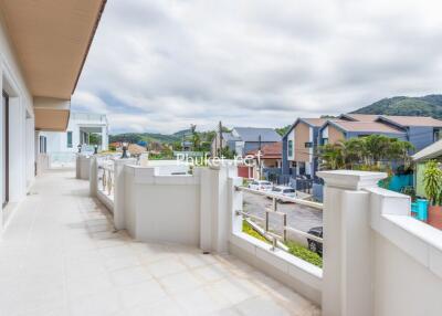 Spacious balcony with a view of neighborhood houses and hills