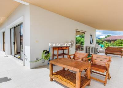 Spacious balcony area with wooden furniture