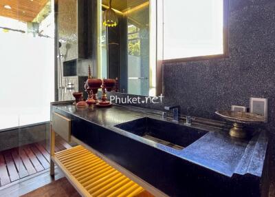 Modern bathroom with black sink and decorative items