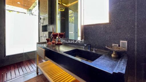 Modern bathroom with black sink and decorative items