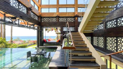 Spacious living room with ocean view and modern staircase