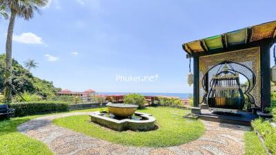 Beautiful garden with a water fountain and a view of the sea