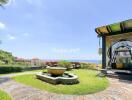 Beautiful garden with a water fountain and a view of the sea