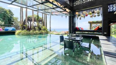 Stunning outdoor dining area with pool and ocean view