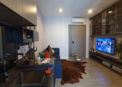 Modern living room with entertainment center and kitchenette