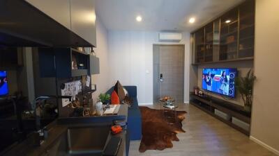 Modern living room with entertainment center and kitchenette